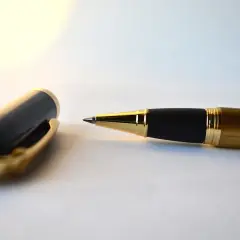 Eleganckie pióro z czarną skuwką i złotymi detalami, gotowe do złożenia ważnej kontrasygnaty.